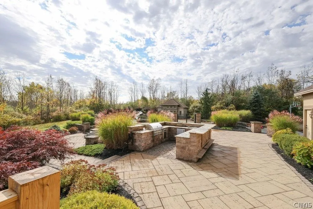 Outside area features a custom-built outdoor grilling and entertainment area.