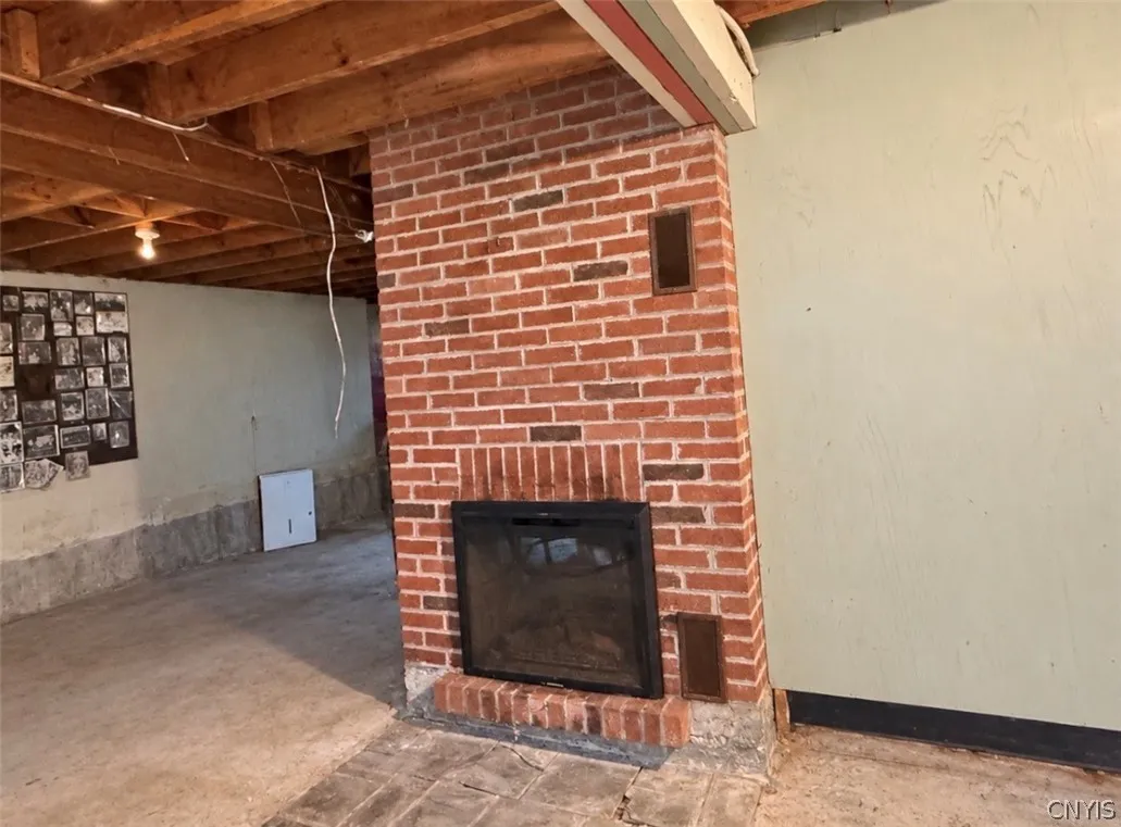Original wood fireplace, currently with an electric insert