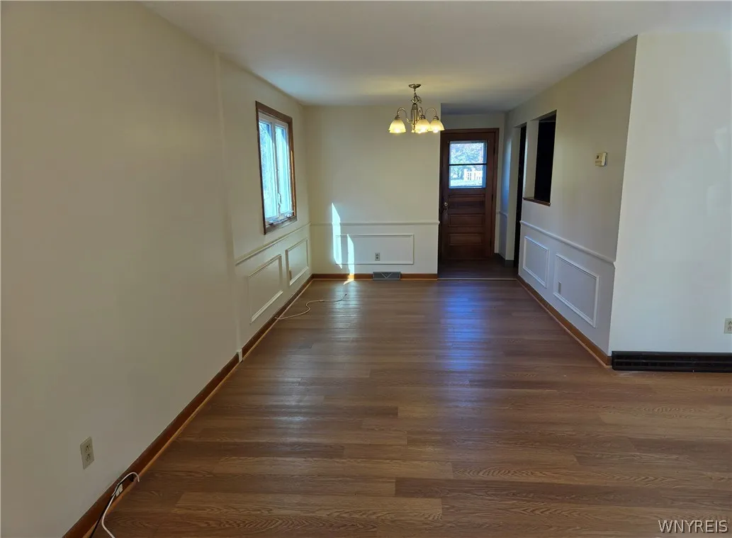 Dining room with wanes coating features a convenient pass-thru to kitchen View shows door with access to backyard!