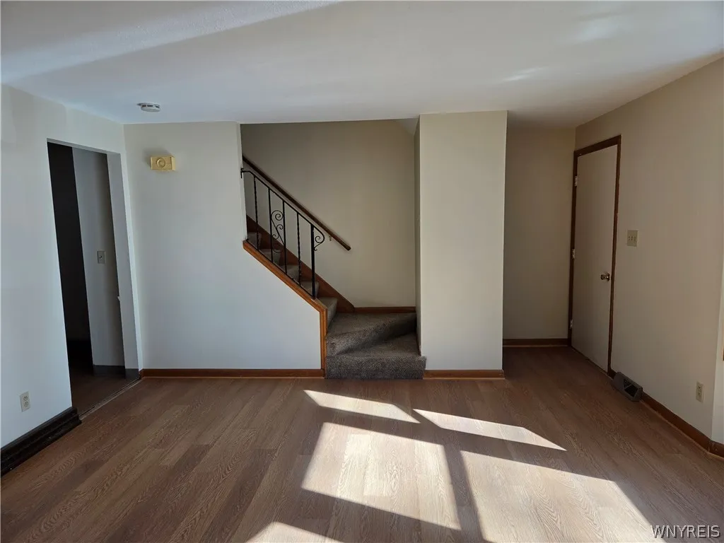 Shows partially open staircase and entry way also access to kitchen
