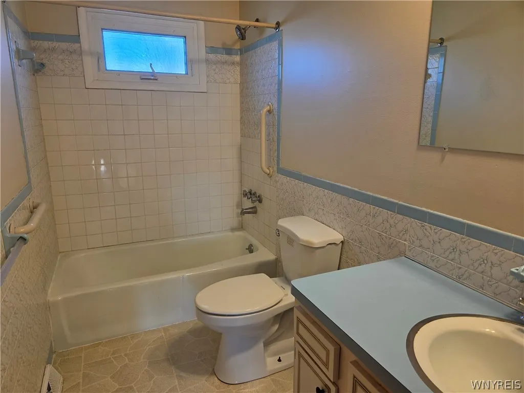 Full bath with tiled shower/tub vanity provides plenty of storage