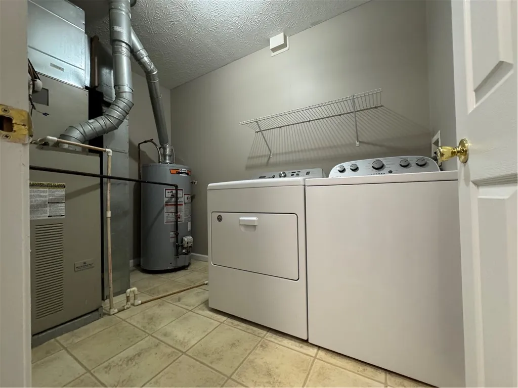 Typical second floor laundry room with full-size washer & dryer