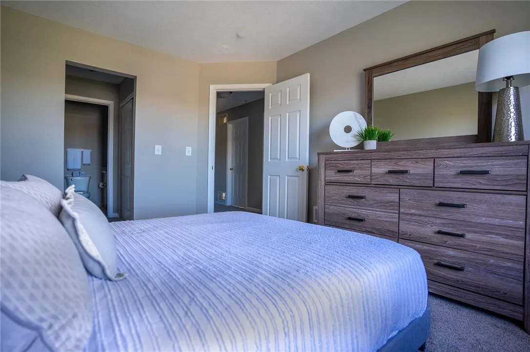 Typical second floor primary bedroom with view to jack-and-jill closet & bathroom and master bedroom entrance door