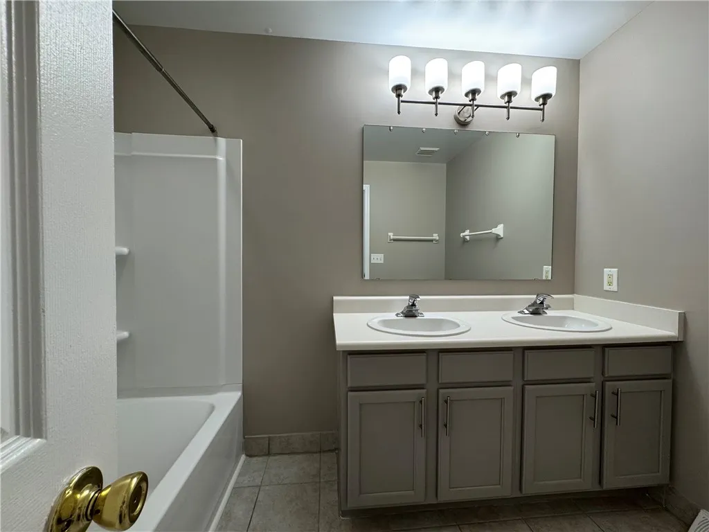 Typical primary full bathroom with shower/tub combo accessible from primary bedroom and from upstairs landing
