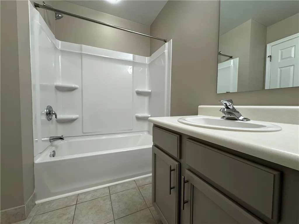 Typical primary full bathroom with shower/tub combo accessible from primary bedroom and from upstairs landing