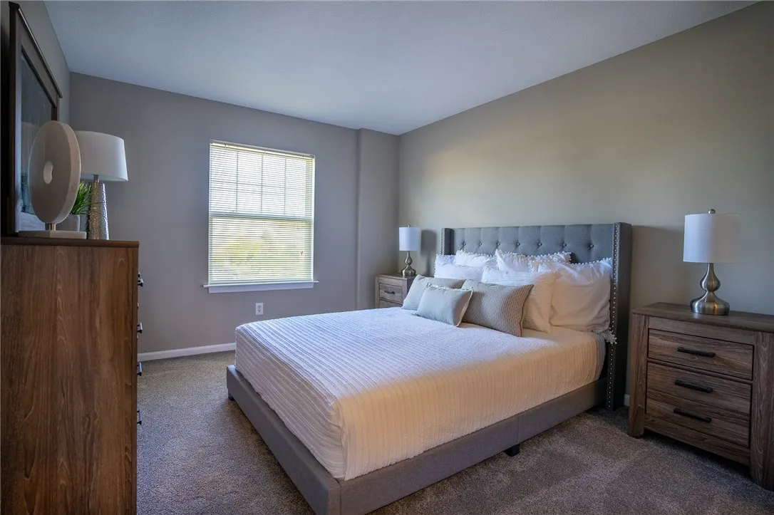 Typical primary bedroom with wall-to-wall carpeting, walk-in closet, and ensuite bathroom