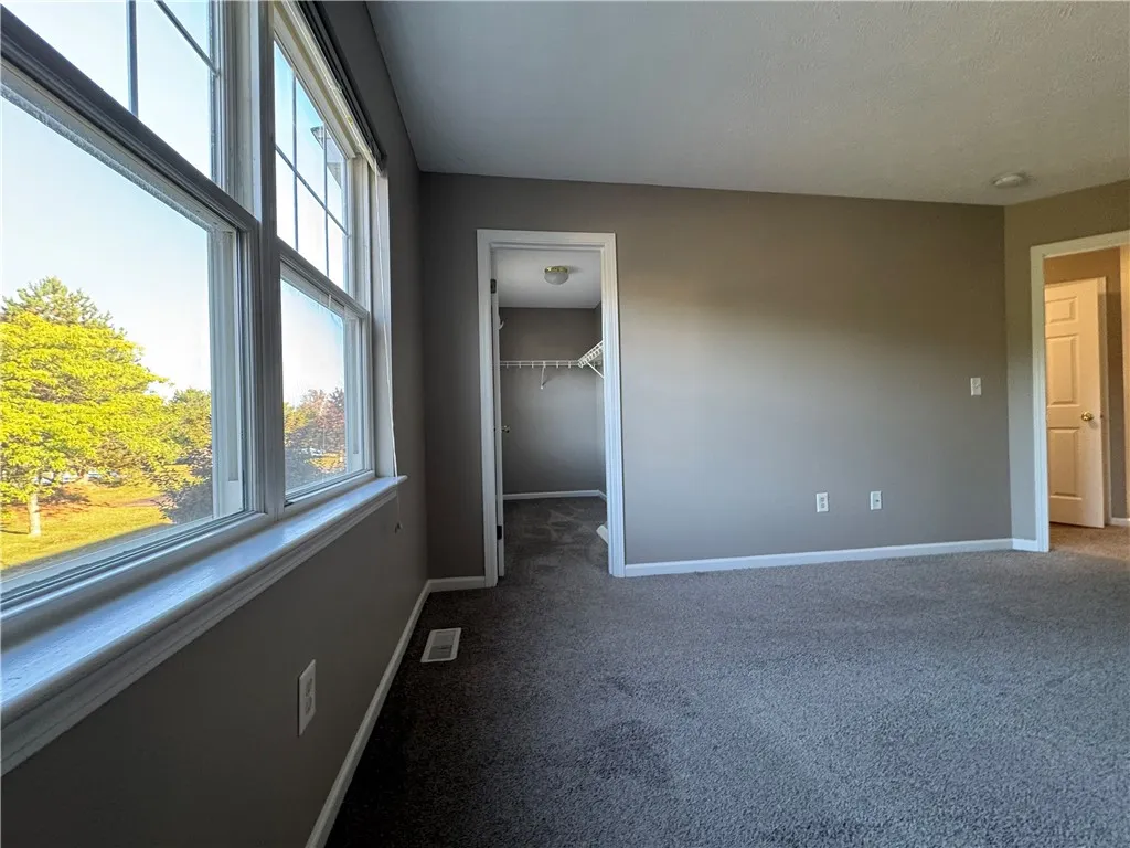 Typical primary bedroom spacious walk-in closet