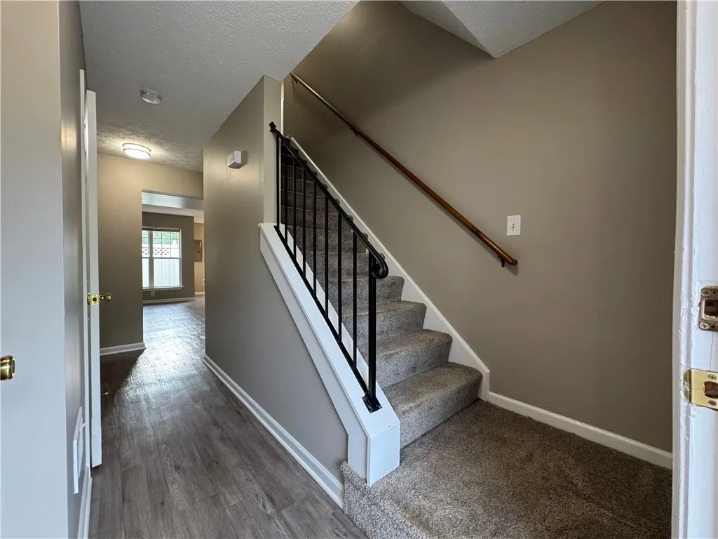 Typical view from inside the front door of stairs to second floor and hallway to great room