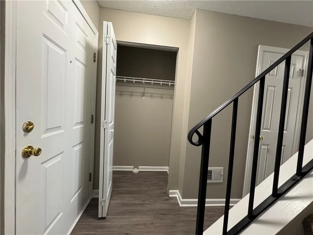 Typical front foyer area with coat closet near stairway to second floor