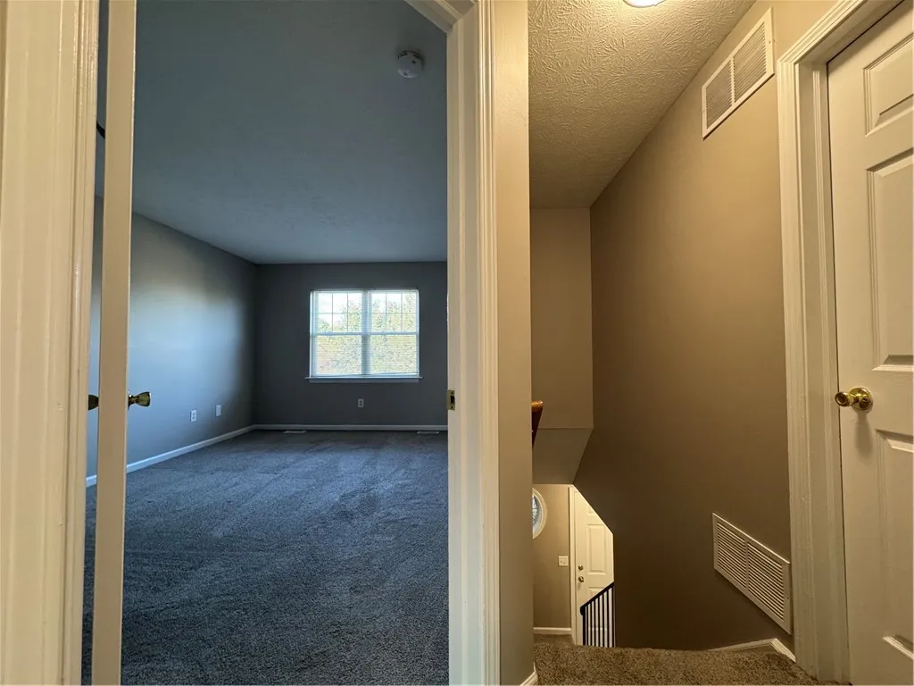 Typical view into primary bedroom from second floor landing
