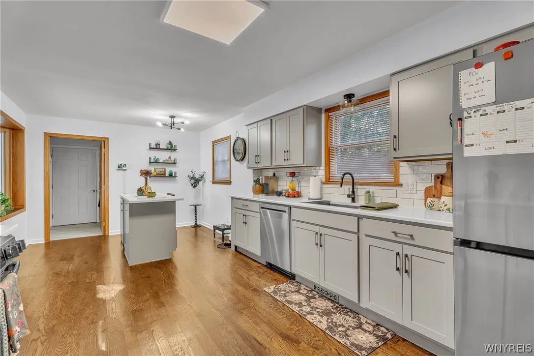 Timeless subway tiled backsplash and beautiful Quartz counters. This is very generously sized kitchen with plenty of room for everyone to gather!