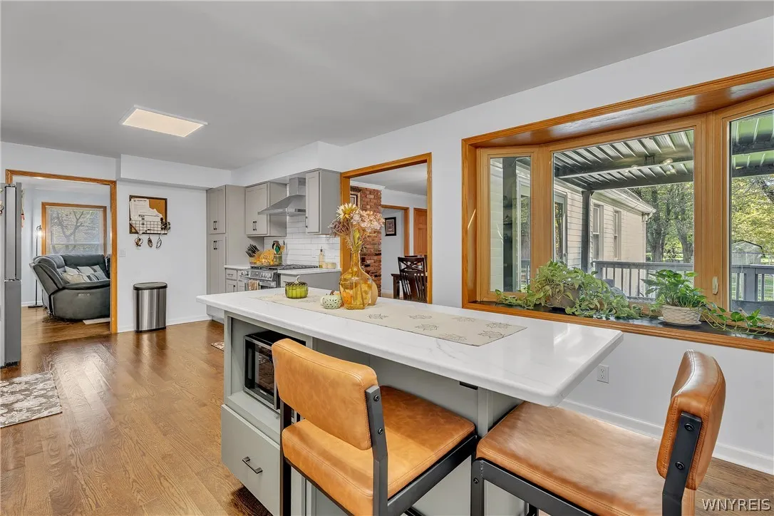 More storage in the large Quartz-topped island and an abundance of natural light through this pretty bay window! Your plants and Herbs will thrive here.