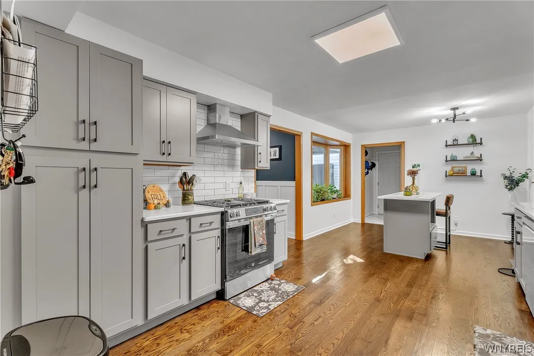 There is an abundance of cabinet and storage space in the kitchen, along with more gleaming hardwood floors.