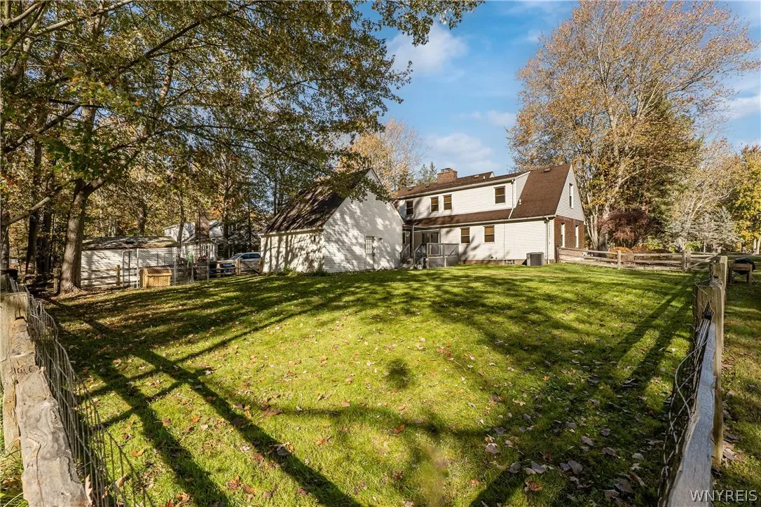 The yard is deep with a portion that is fenced.