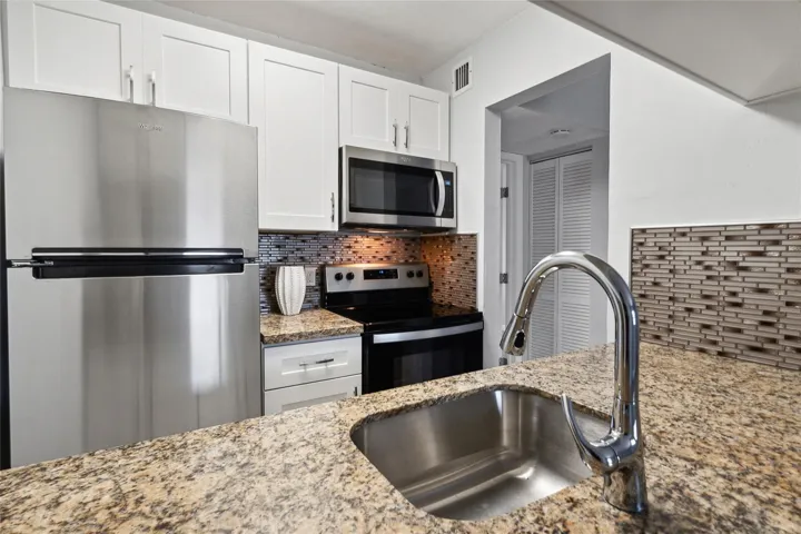 New cabinets, marble counters
tile backsplash and stainless appliances