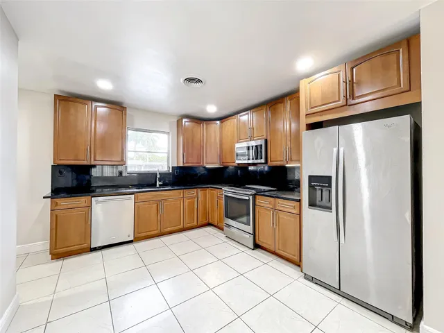 Lots of Storage with tall 42" wall cabinets, stainless appliances and granite counters
