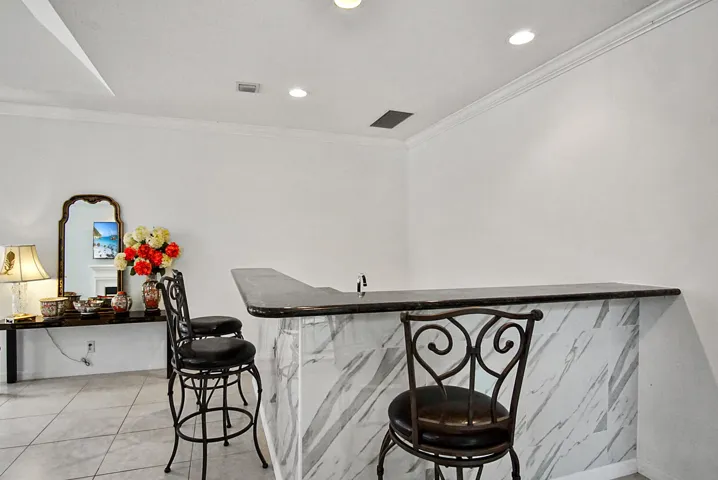 Granite topped bar. Holds about 8