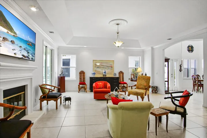 Large living room with wood burning fireplace, granite bar.