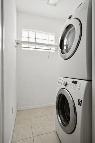 Washer/dryer stack lots of room for hanging clothes and you can add shelves for storage.