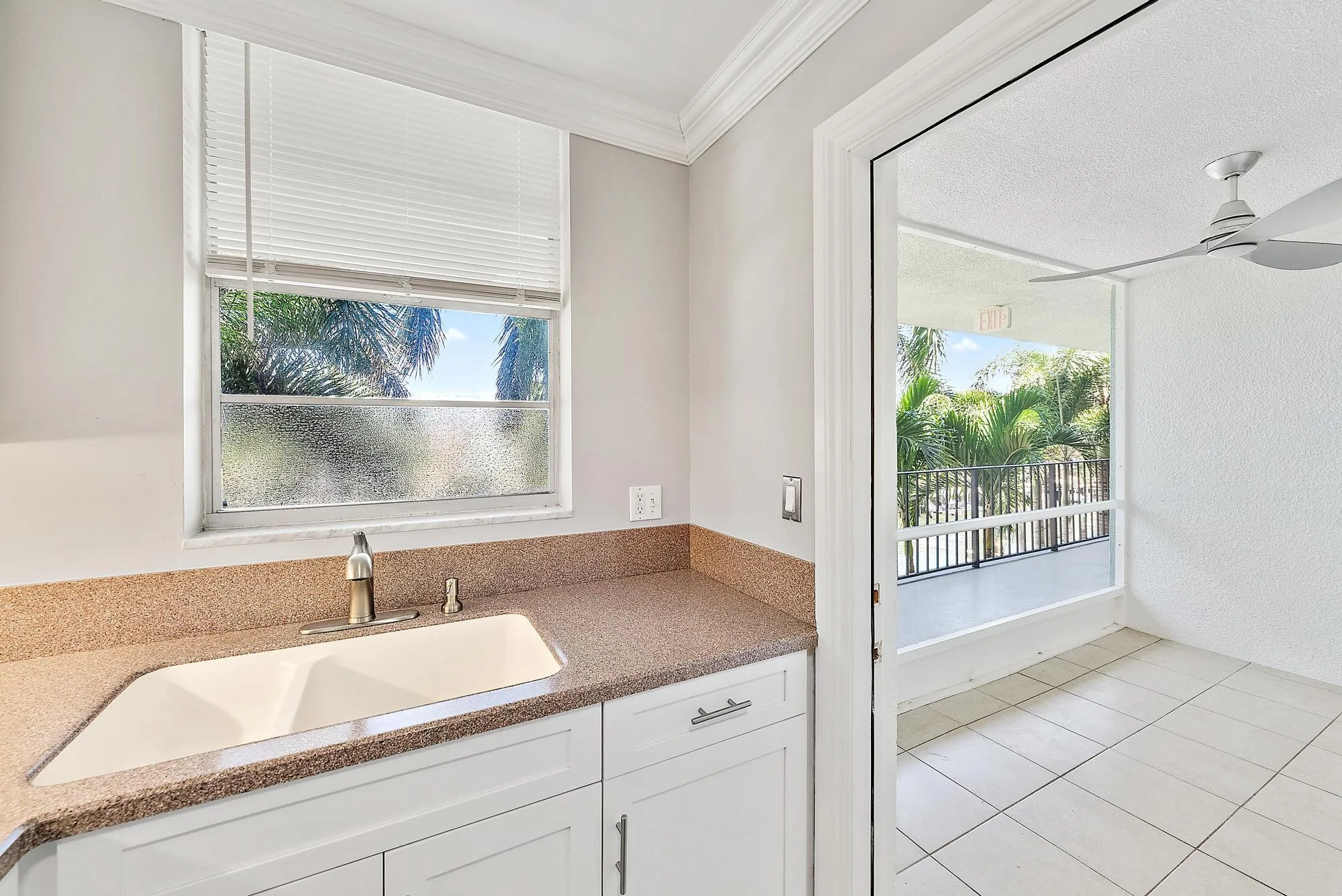 Kitchen sink with entrance to patio.