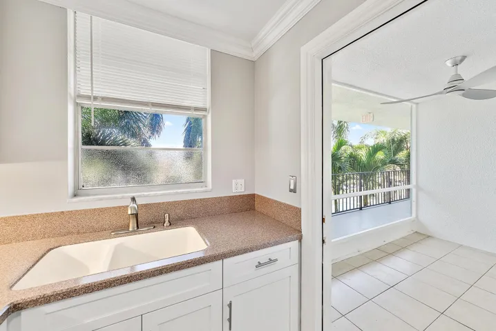 Kitchen sink with entrance to patio.