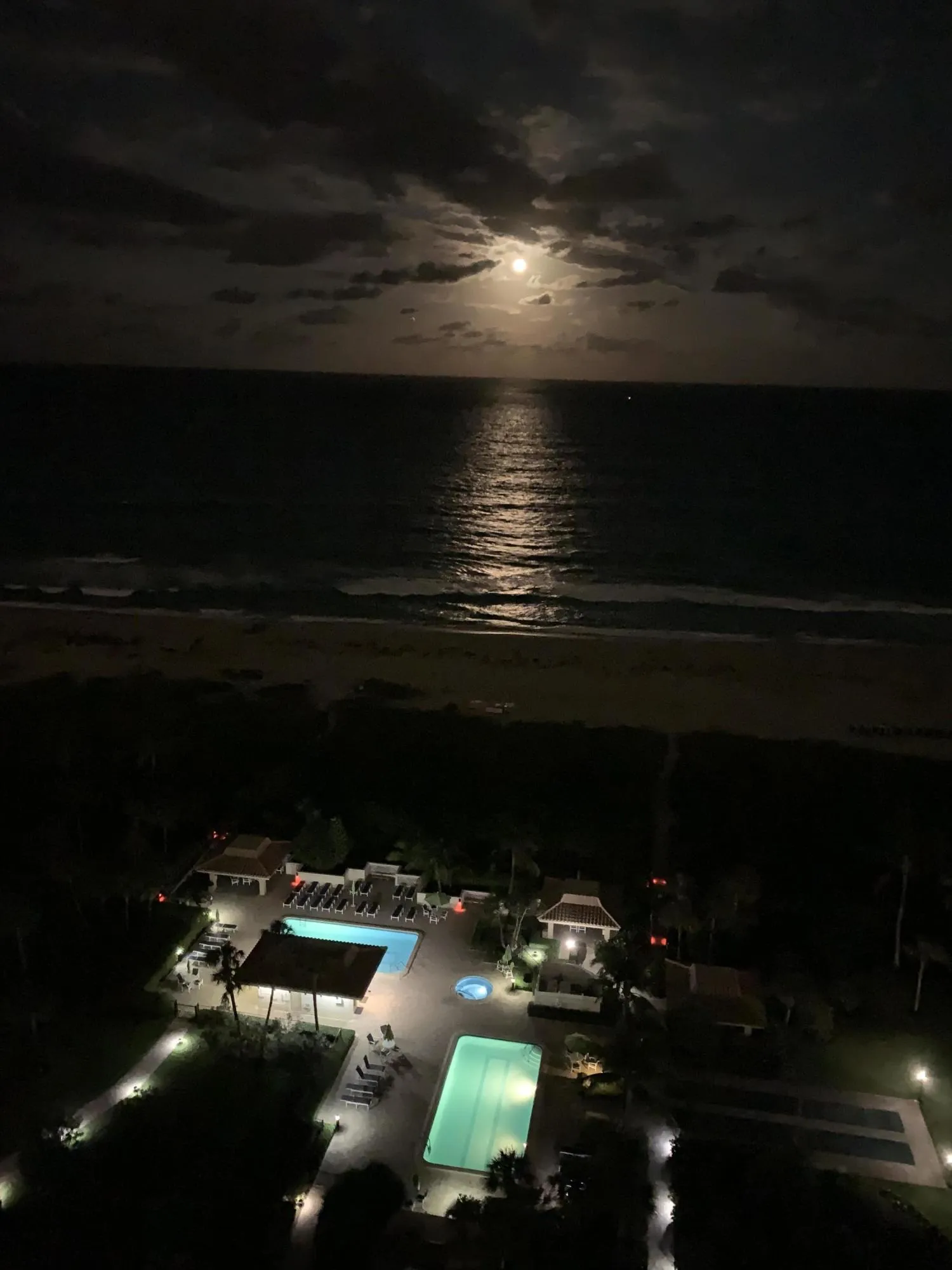 Night View of Ocean, pools, & grounds