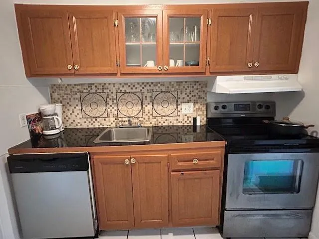 Wood cabinets and stainless steel range and dishwasher