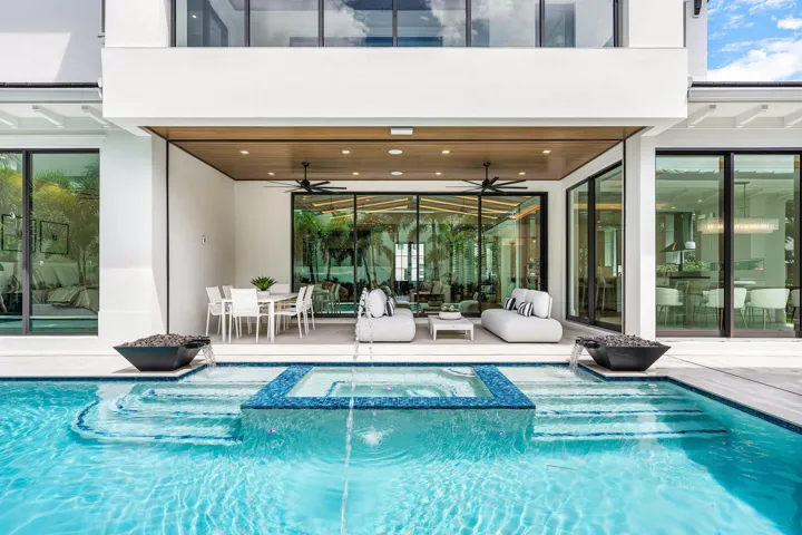 Tranquil heated pool & spa featuring gas lit firebowls