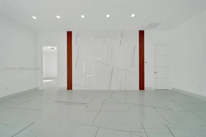 ENTERTAINMENT AREA WATERFALL OF TILE WITH MAHOGANY ACOUSTIC PANEL