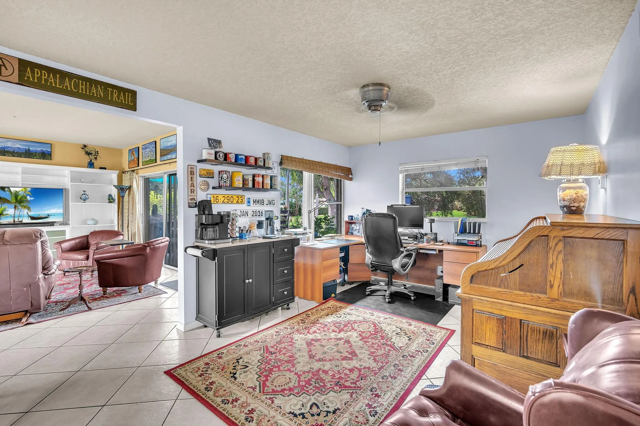 There is sliding door leading to the backyard next to the coffee station. In front of the desk, you have stunning water views