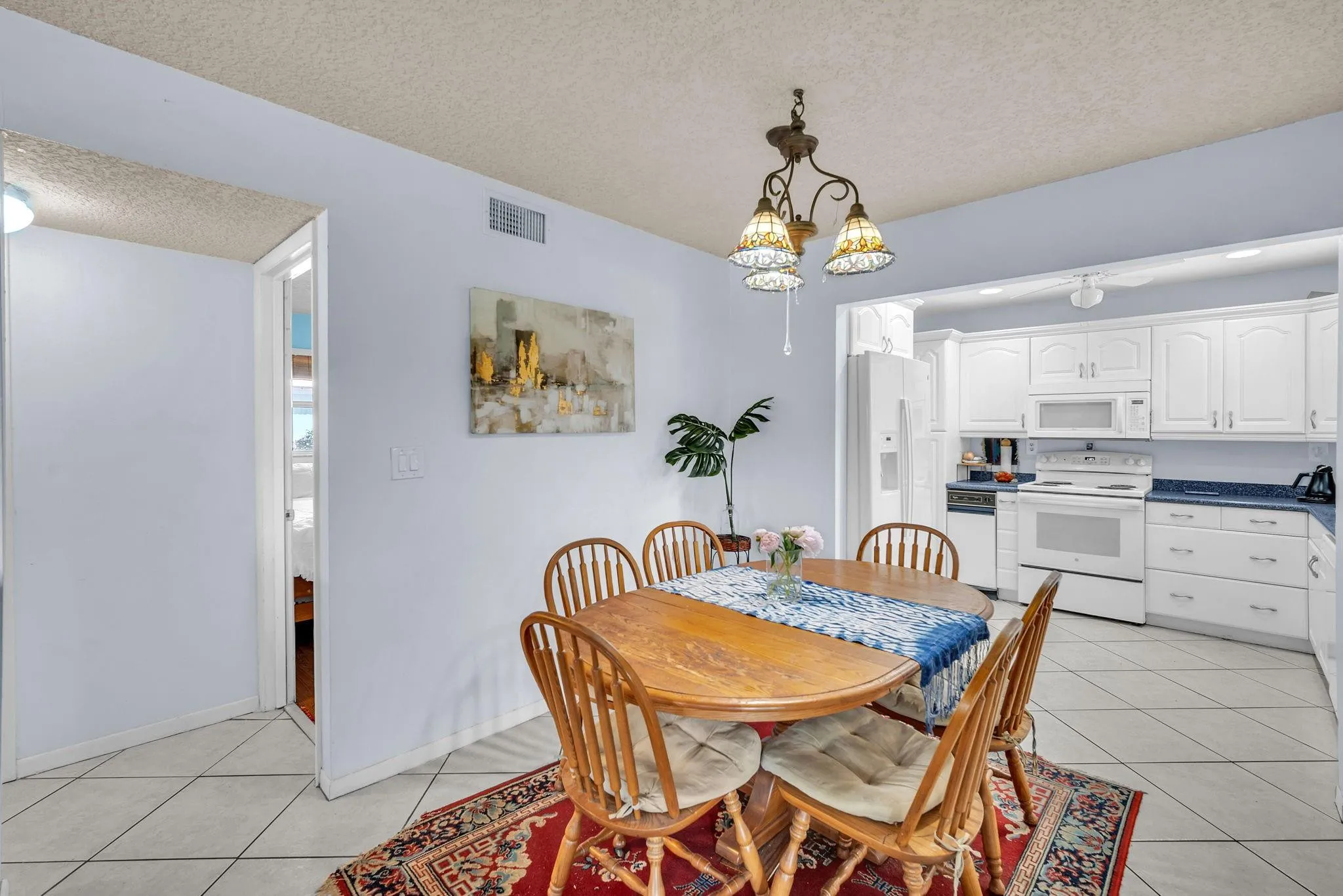 Two bedrooms and a full bathroom beyond the dining room