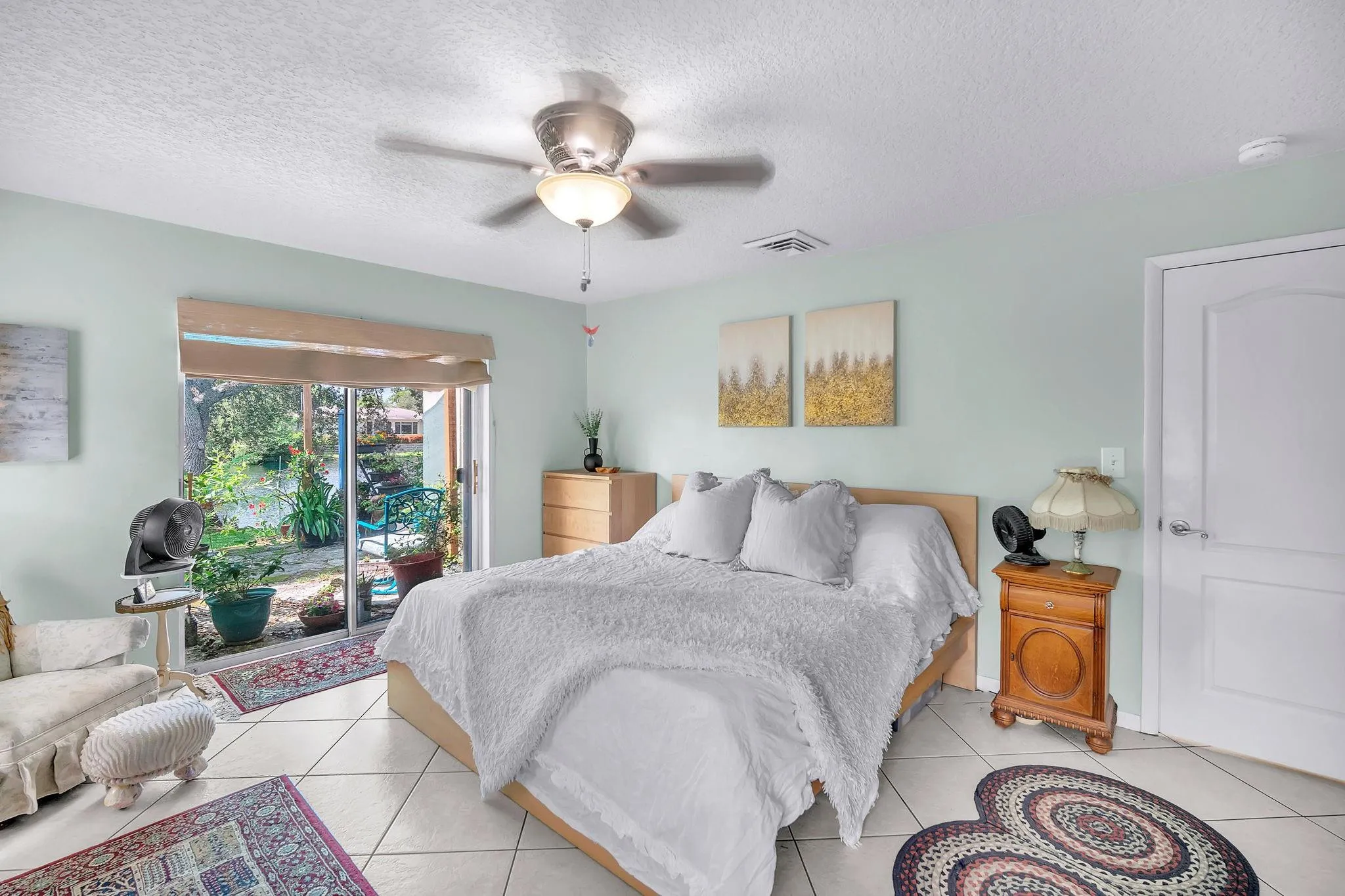Primary bedroom with access to the backyard and features a walk-in closet.