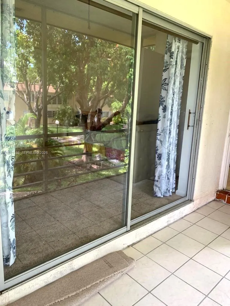 BEDROOM SLIDERS TO SCREENED TILED PATIO WATER VIEW