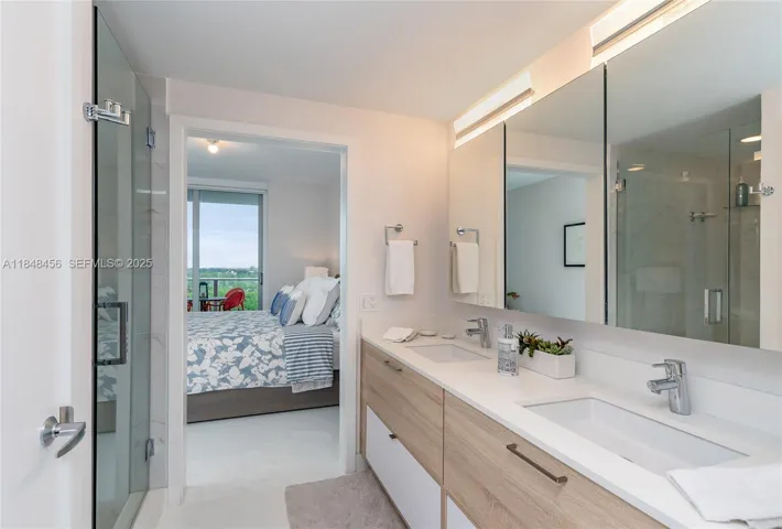 Master Bathroom - Designer lamps, mirror cabinets for additional storage. 2 lower drawers were built to replace the shelves. Dveloper's Floors were changed to match the white porcelain floors