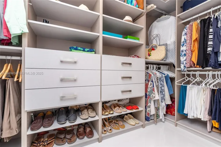 Large Master Walk-in Closet - custom made with light beige tones