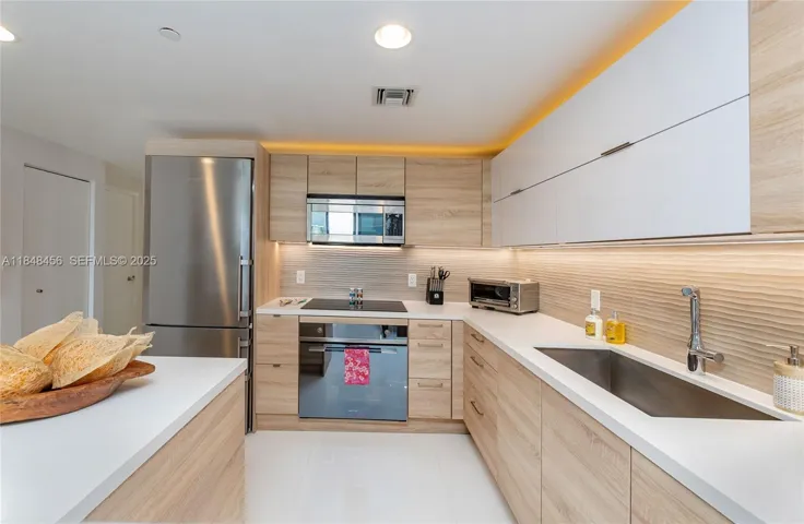 Fully equipped kitchen, quartz counter tops, upper cabinet was added to replace the simple shelf. All lower shelves were converted to soft close drawers.