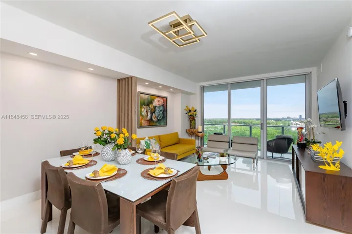 Another view of the dining room area with the living room in the back. Beautiful designer lamp