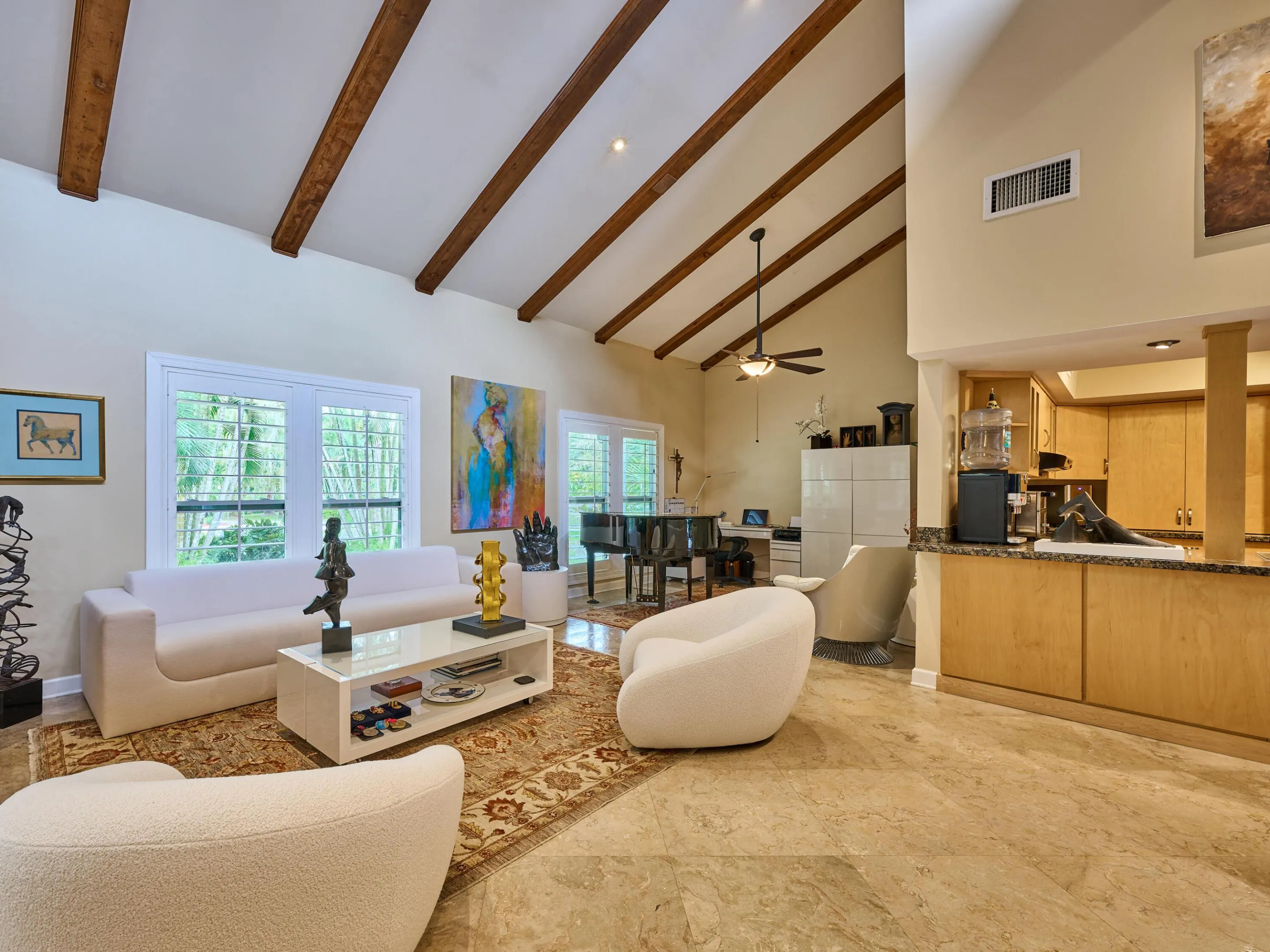 With beamed ceilings, open to the kitchen, formal and informal living and dining await.