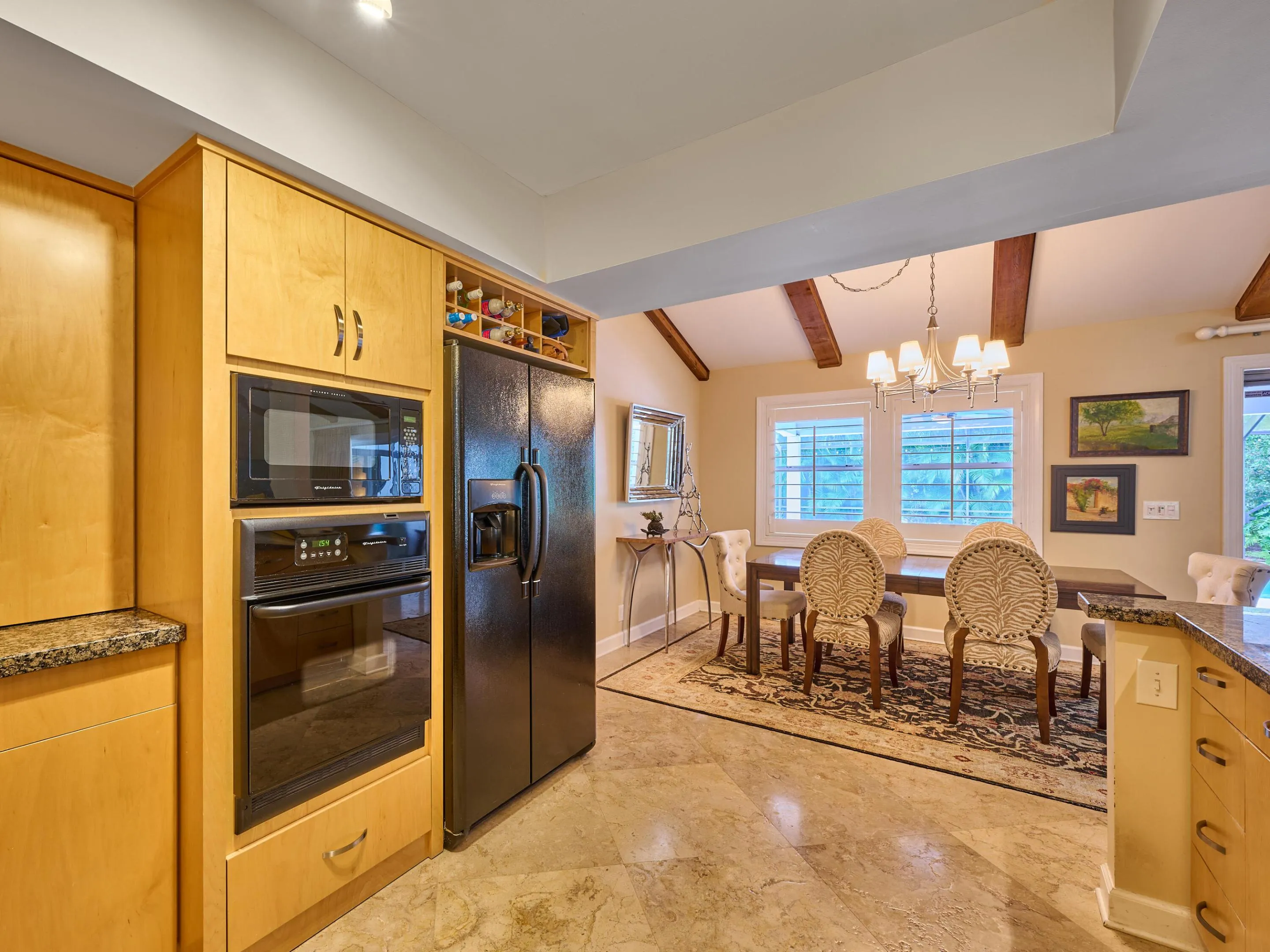 Making an easy transition to the dining room is a breeze from the kitchen too, all while enjoying the view to the pool.
