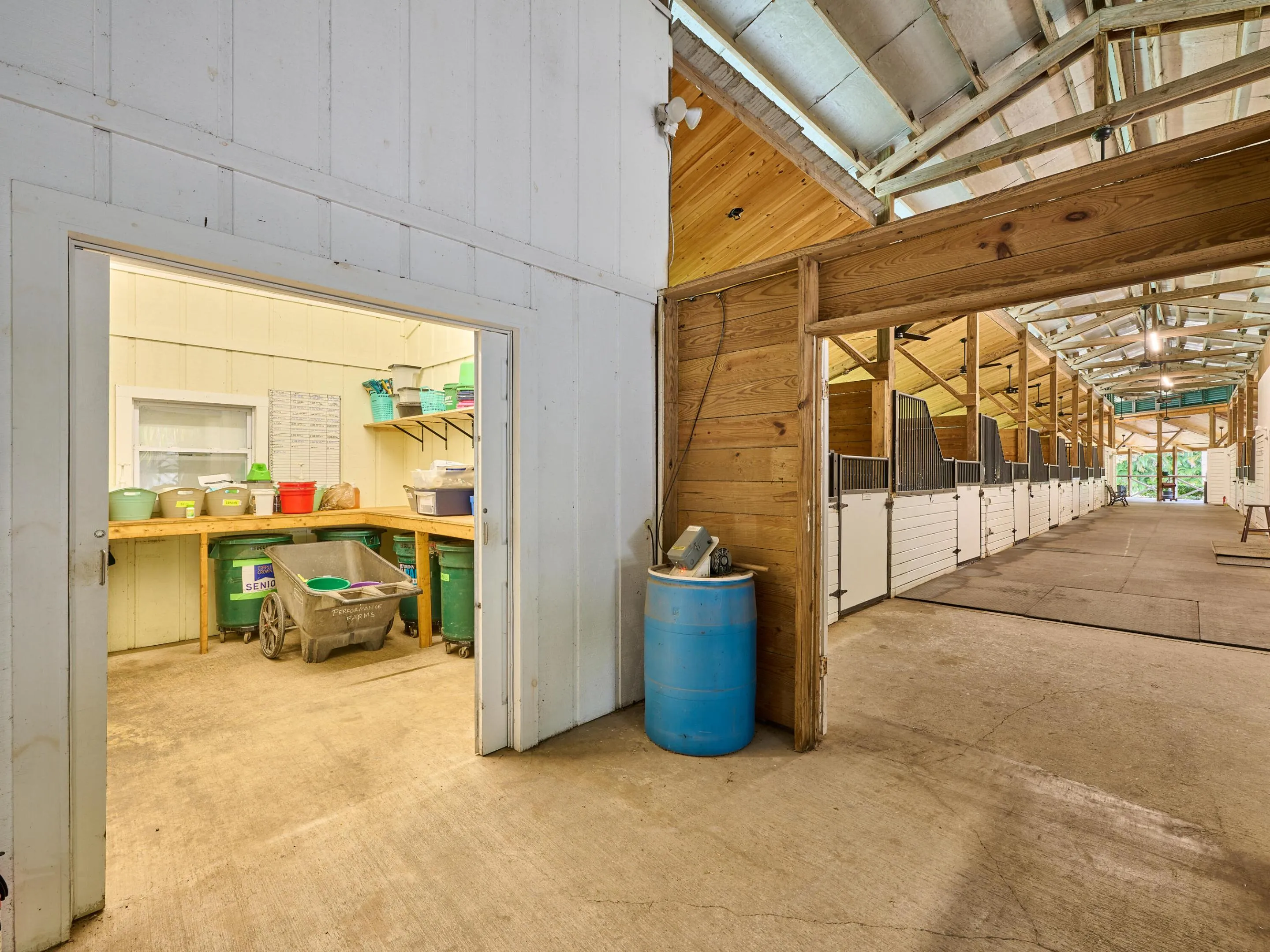 Spacious and enclosed feed room with additional feed storage in adjacent closet.