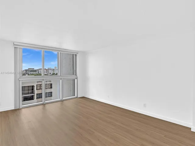 Primary bedroom, staged to show views to balcony and ocean
