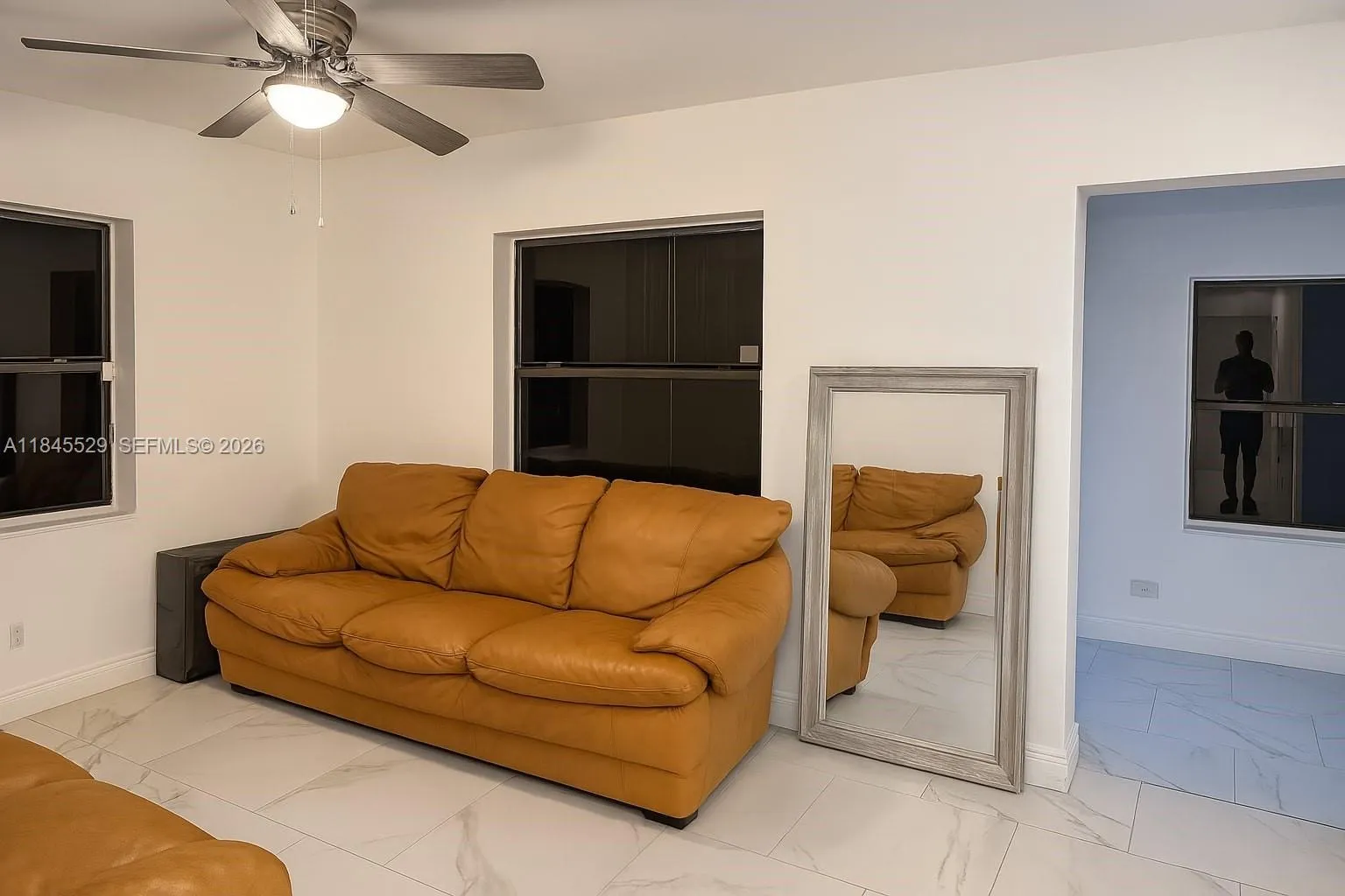 Cozy living space connects living, dining, kitchen for open feel