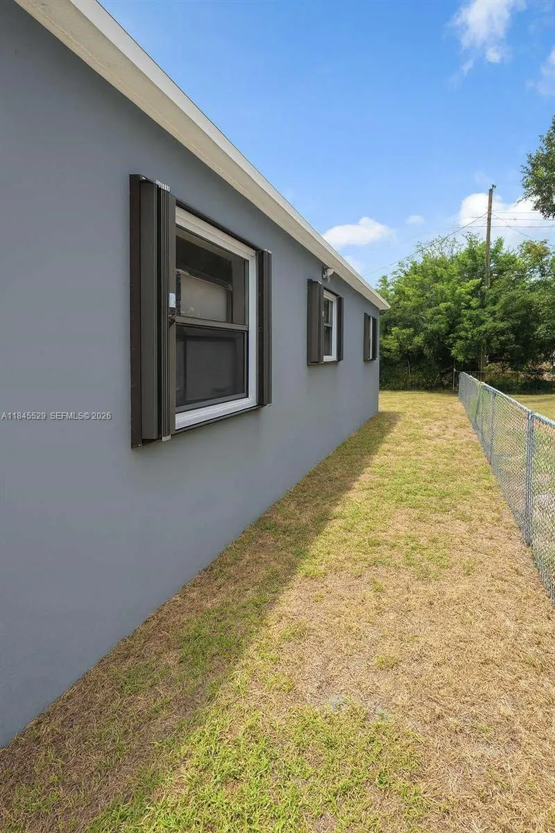 Chain-link fence, hurricane shutters, several windows for natural light