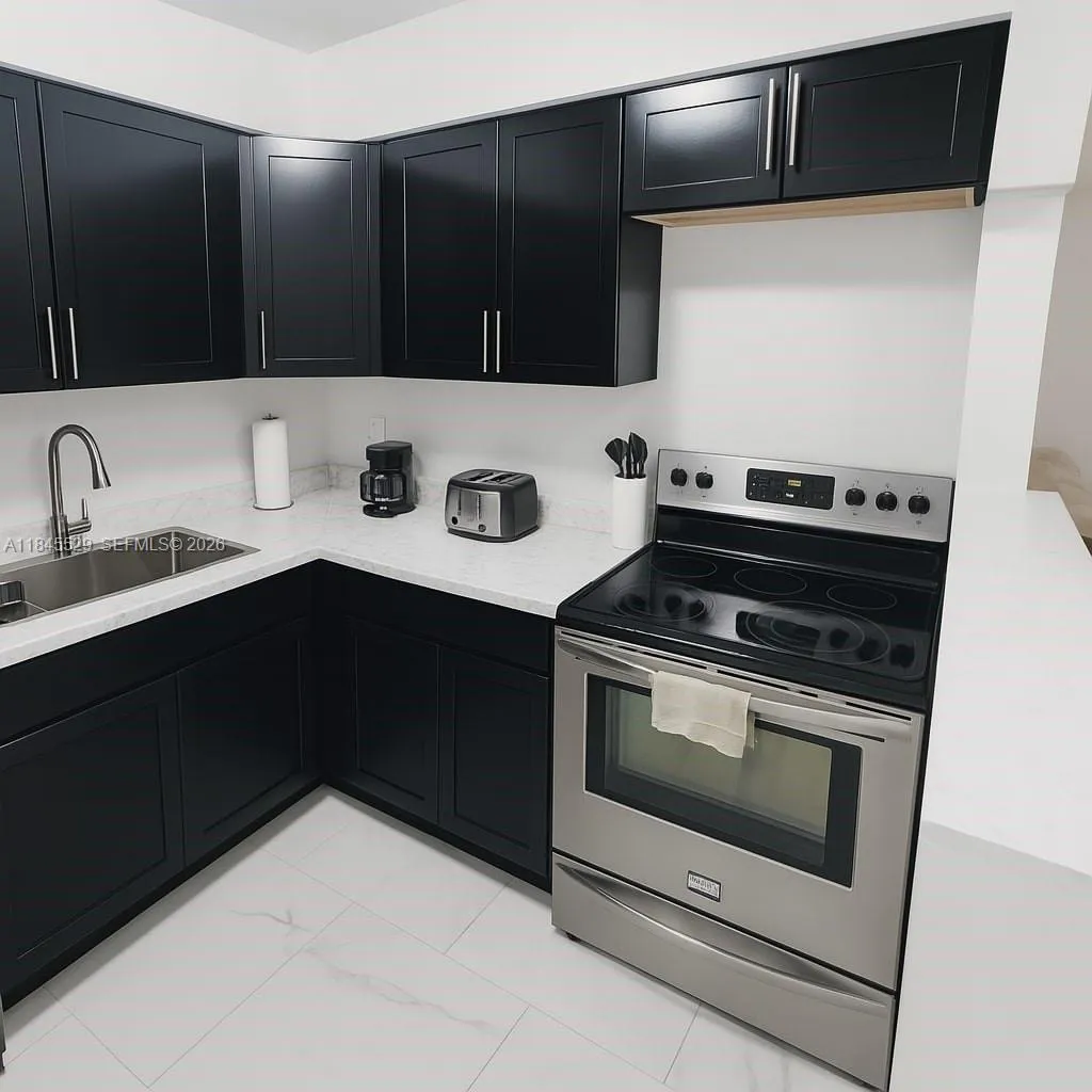 Stainless steel range/oven with newer black shaker cabinets