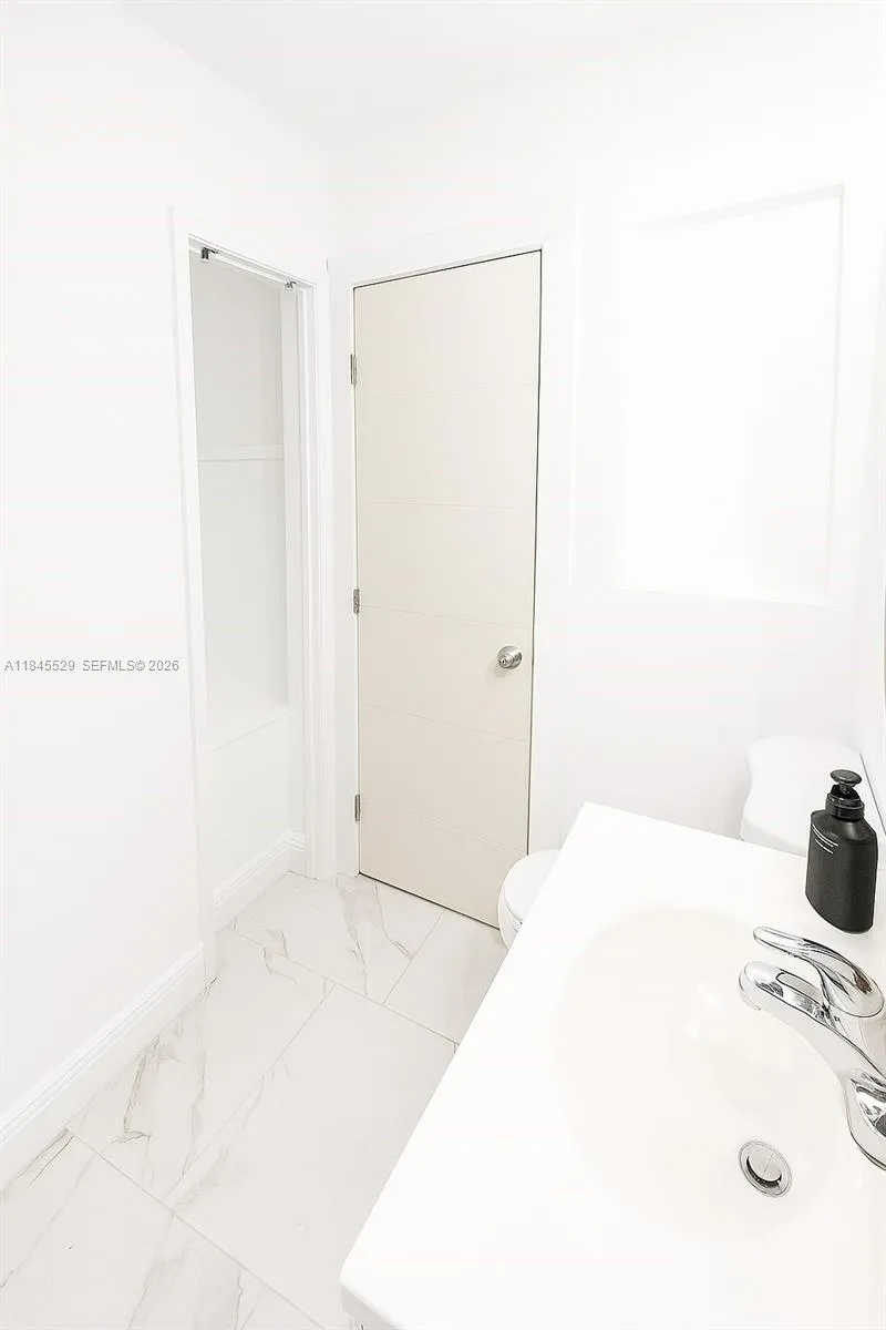 Towel hub behind bathroom door for added space