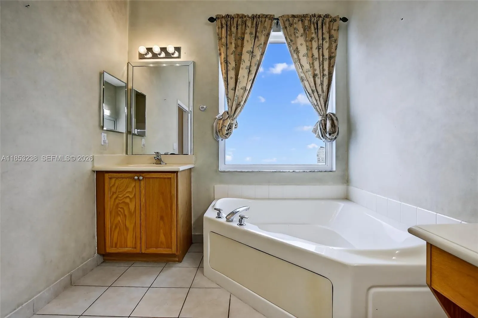 Spacious primary bath with two vanity areas & separate tub & shower