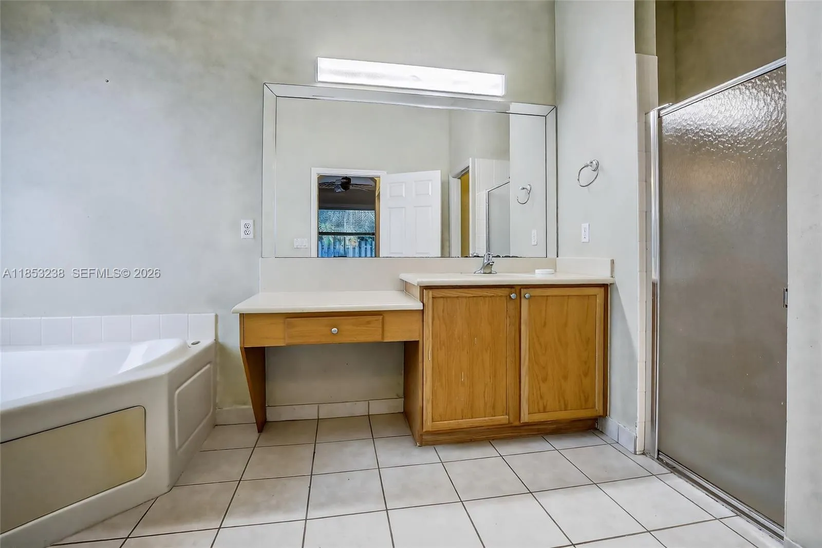 Spacious primary bath with two vanity areas & separate tub & shower