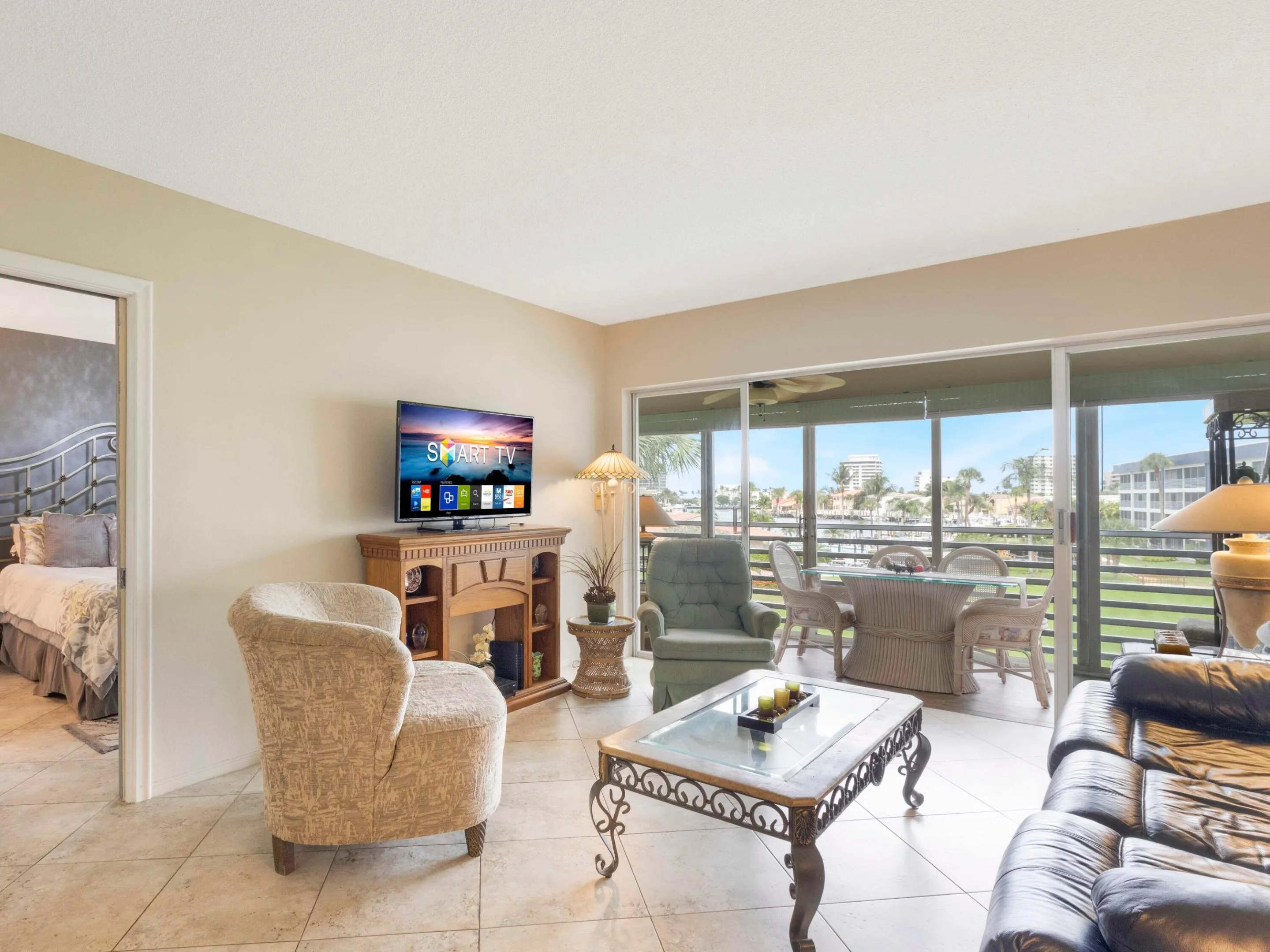 Living area opens to screened balcony with serene water views while enjoying the coastal breeze