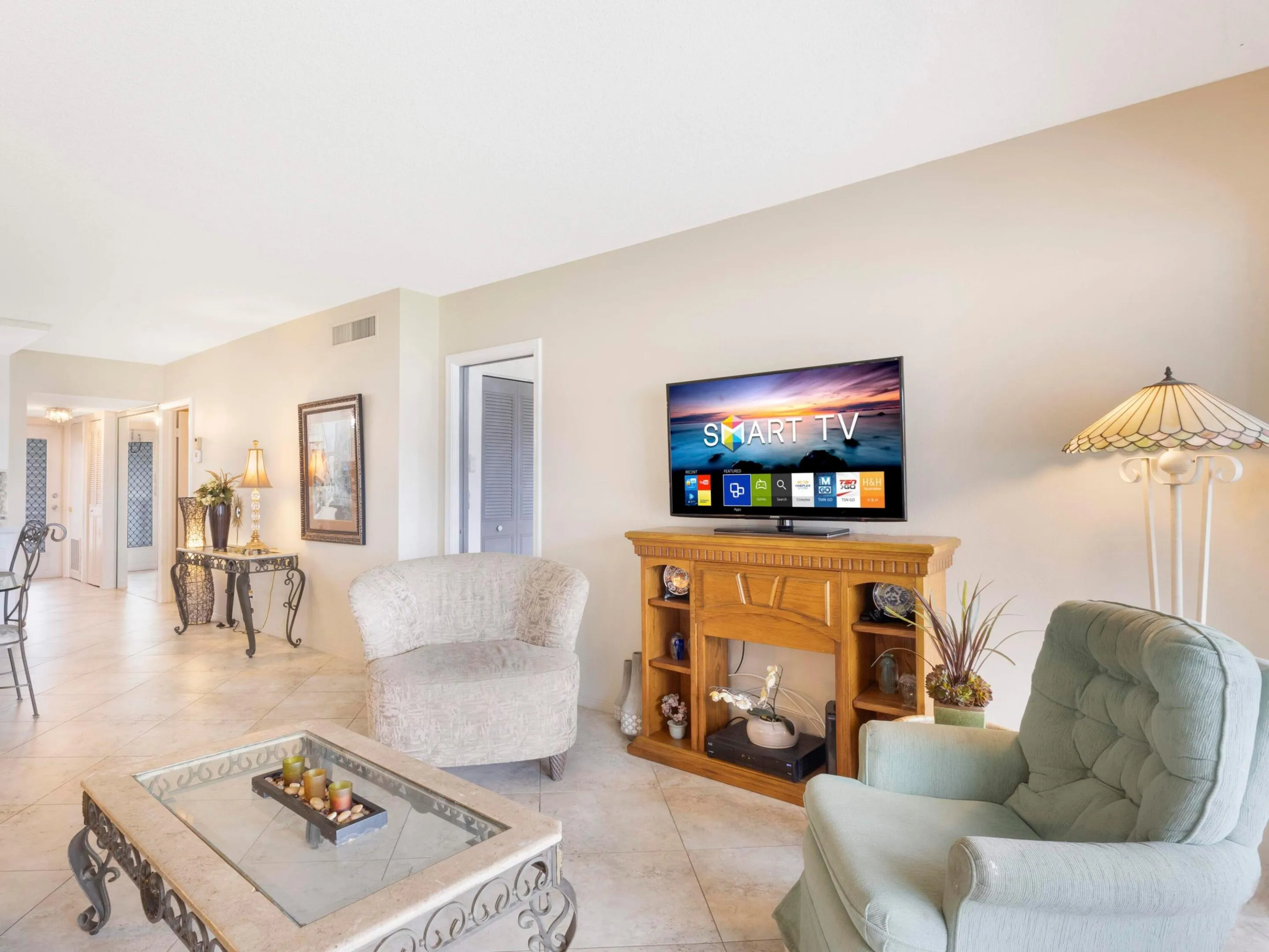 Living area opens to screened balcony with serene water views while enjoying the coastal breeze
