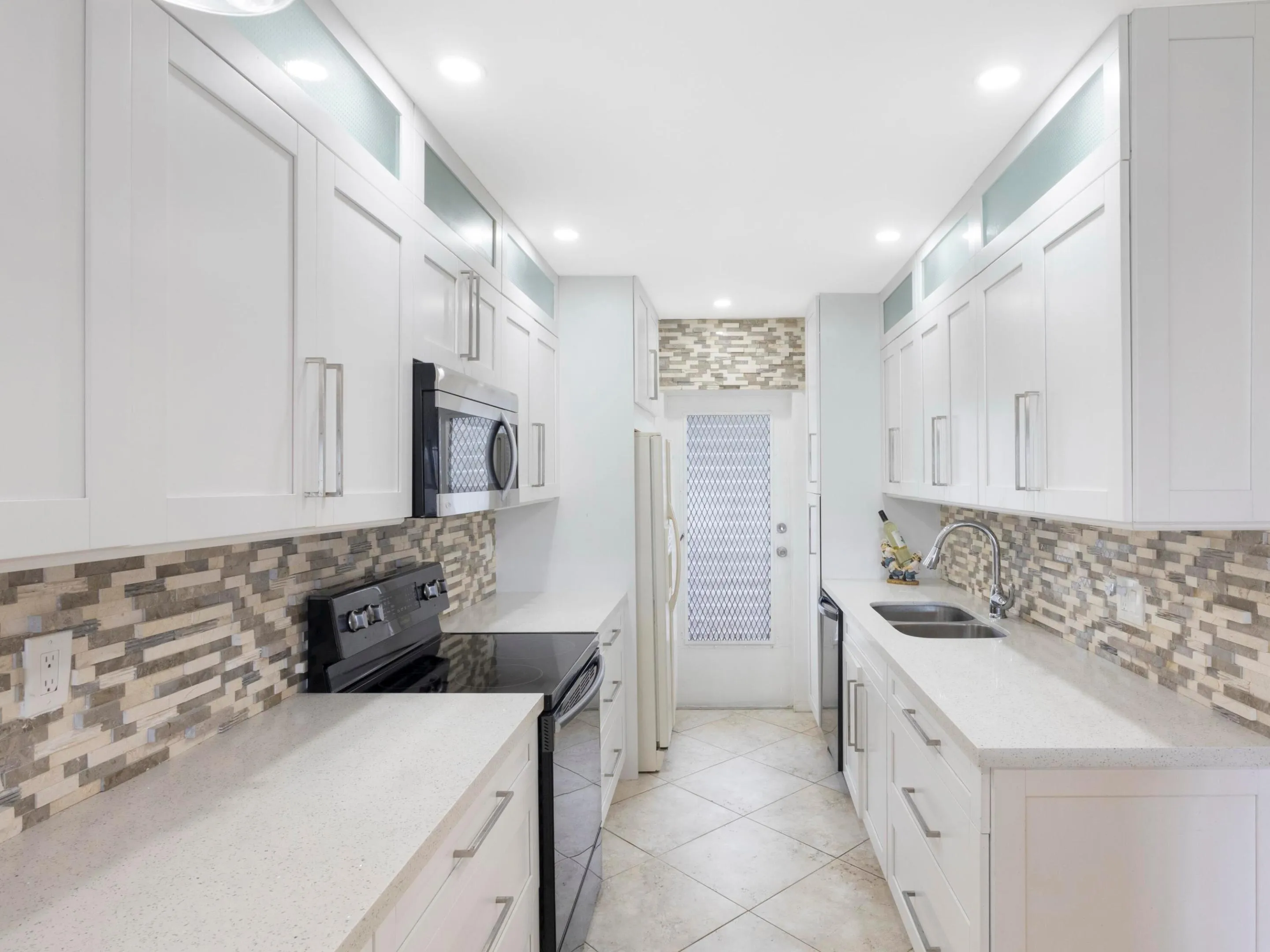 Recessed lighting and designer finishes complete the contemporary feel, making the kitchen as functional as it is beautiful